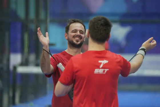 Two players in red high-fiving after winning a point