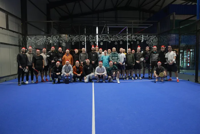 Forty players in Santa hats on one court at the Christmas charity tournament
