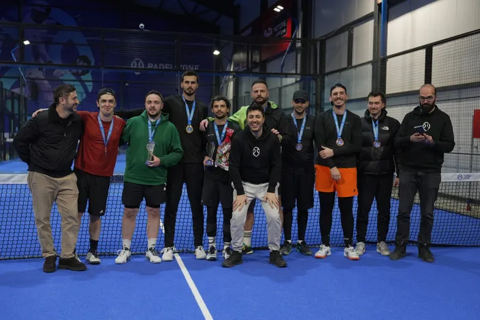 Tournament winners with their medals and trophies, lined up at the net