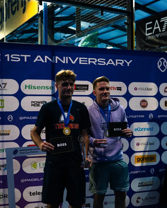 Winners with their medals in front of the Padel Zone first anniversary banner at Padel Fest