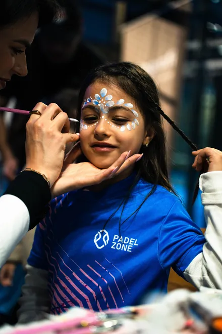 A girl getting her face painted at the Padel Fest kids day