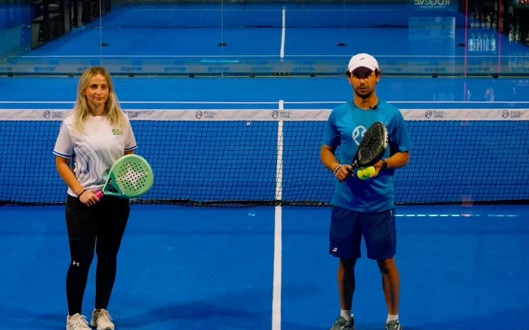 Benita and Osman standing side by side on court to show doubles positioning