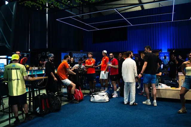 Players gathering between matches at the Prishtina Padel Open 2026, the tournament banner behind them